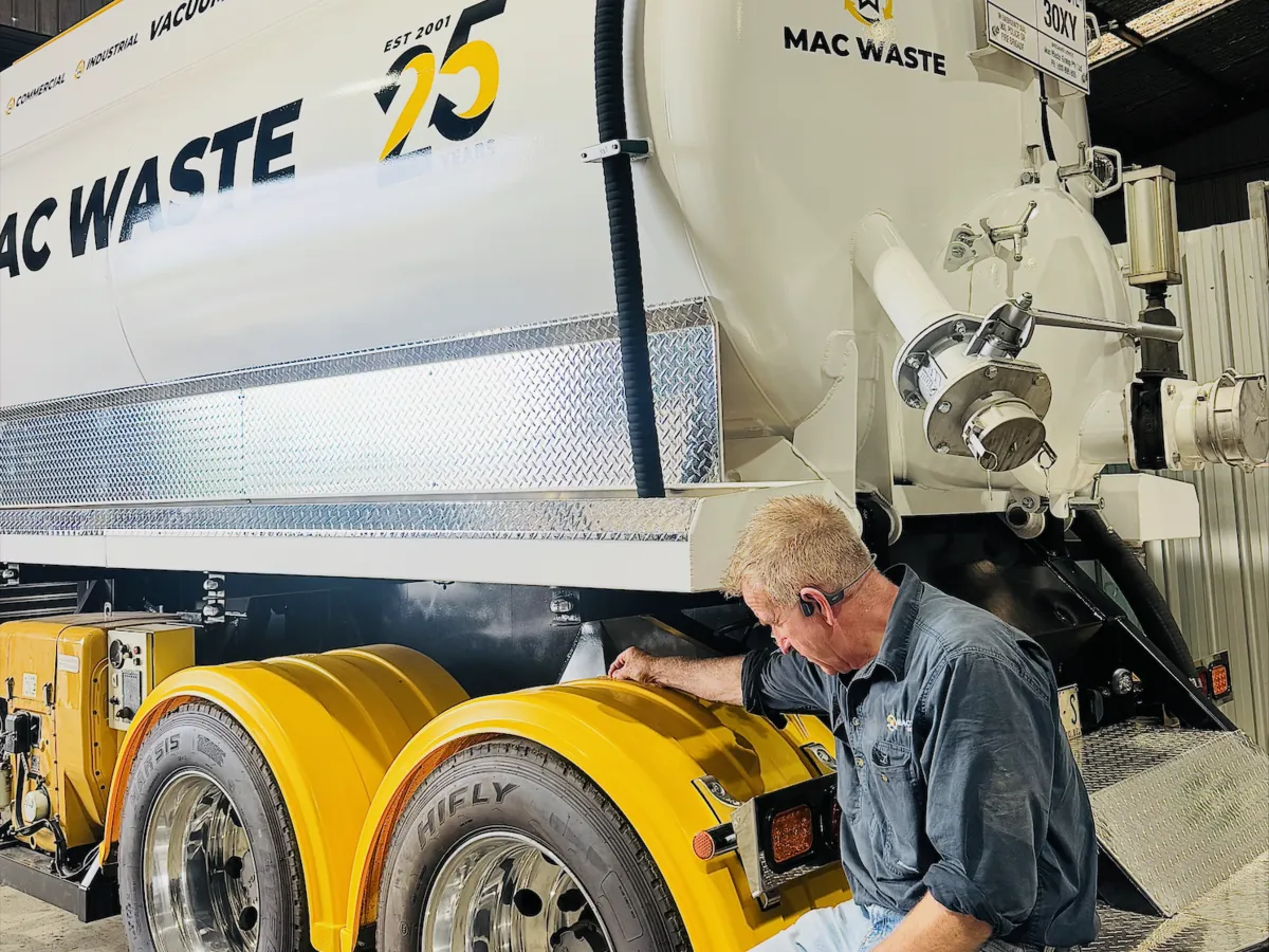 Mac Waste operator working at the rear of a vacuum tanker