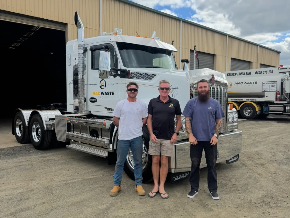 Bruce Mack with his sons at the Maffra depot, in front of a Mac Waste prime mover