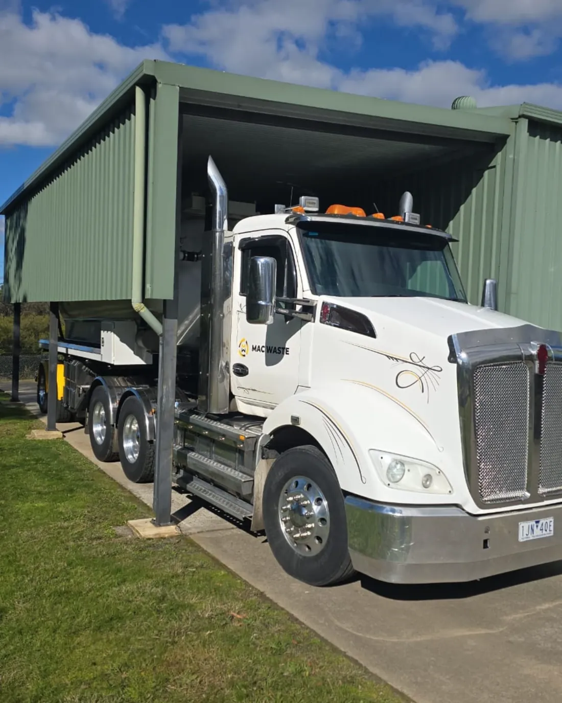 Mac Waste prime mover and tipping trailer parked at the depot